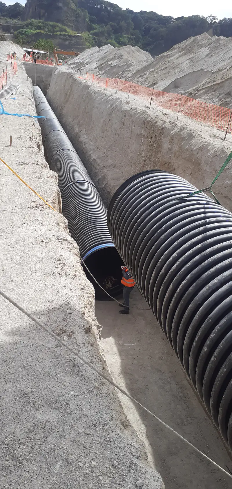 Tubería corrugada de gran diámetro tendida dentro de una zanja.